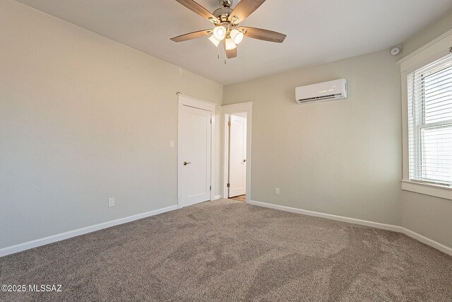 carpeted spare room with ceiling fan, a healthy amount of sunlight, and a wall mounted AC