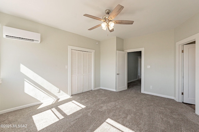 unfurnished bedroom with carpet floors, a wall mounted AC, ceiling fan, and a closet