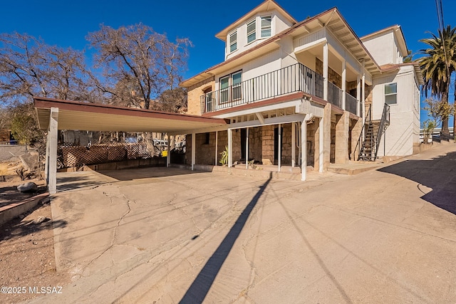 view of front of home featuring a carport and a balcony