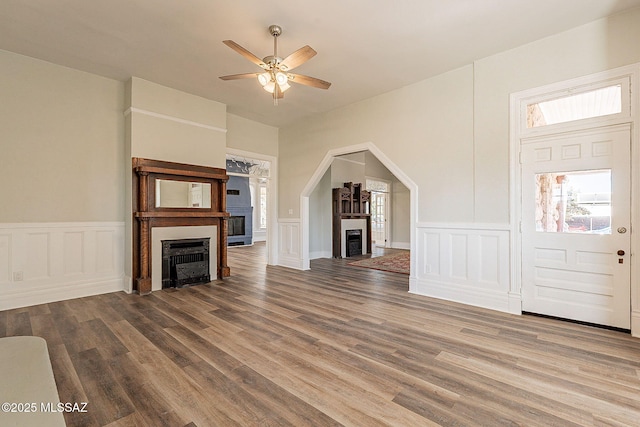unfurnished living room with hardwood / wood-style floors and ceiling fan