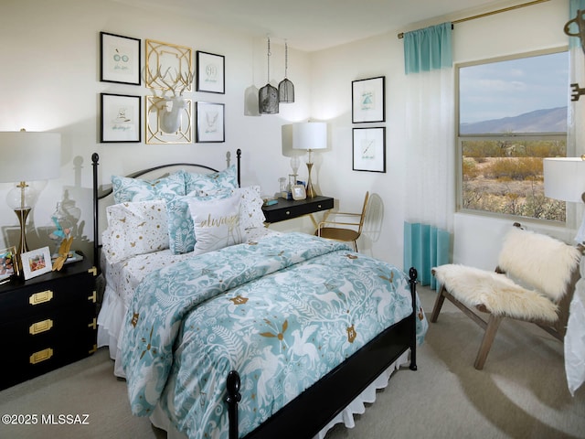 bedroom with light colored carpet and a mountain view