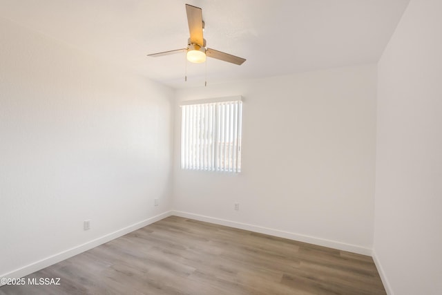 empty room with ceiling fan and light wood-type flooring