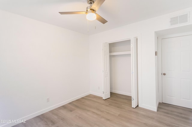 unfurnished bedroom with ceiling fan, light hardwood / wood-style floors, and a closet