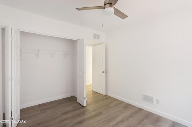 unfurnished bedroom with ceiling fan, hardwood / wood-style floors, and a closet