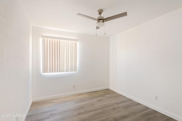 empty room with light hardwood / wood-style flooring and ceiling fan