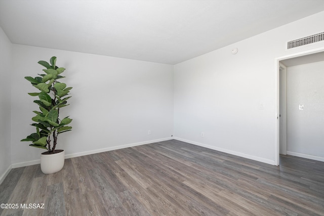 empty room featuring dark hardwood / wood-style flooring