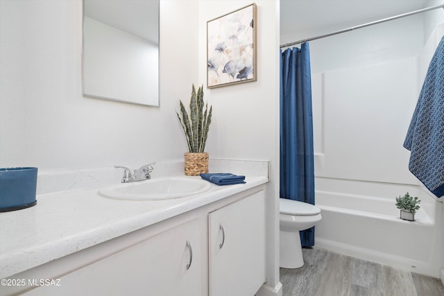 full bathroom with wood-type flooring, shower / bath combo, vanity, and toilet