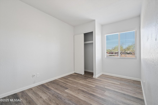 unfurnished bedroom with a closet and light hardwood / wood-style flooring