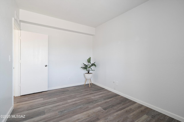 unfurnished room with dark hardwood / wood-style floors