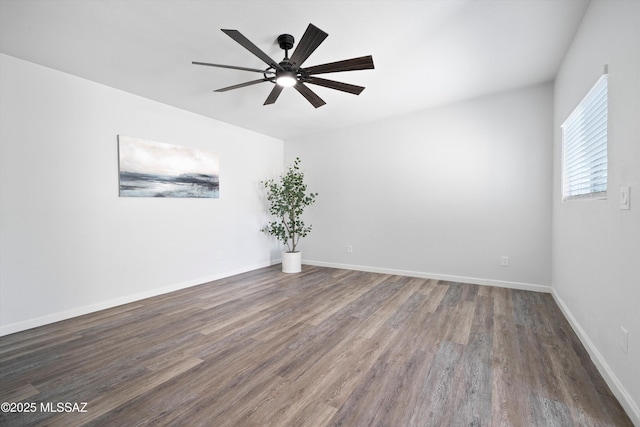 empty room featuring dark wood-type flooring and ceiling fan