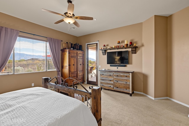 bedroom featuring access to exterior, light colored carpet, and ceiling fan