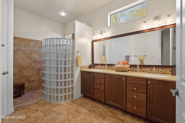 bathroom featuring a shower, vanity, and decorative backsplash