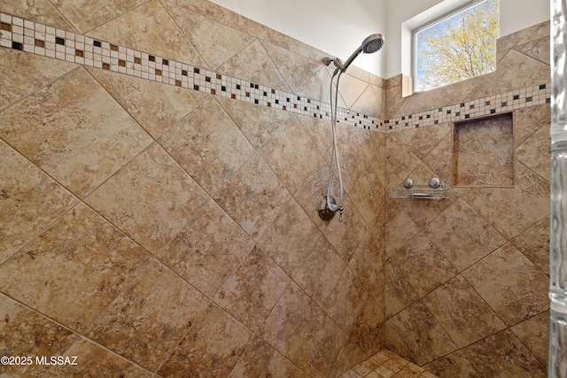 interior details featuring a tile shower