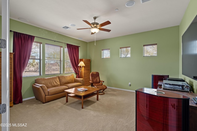 carpeted living room featuring ceiling fan