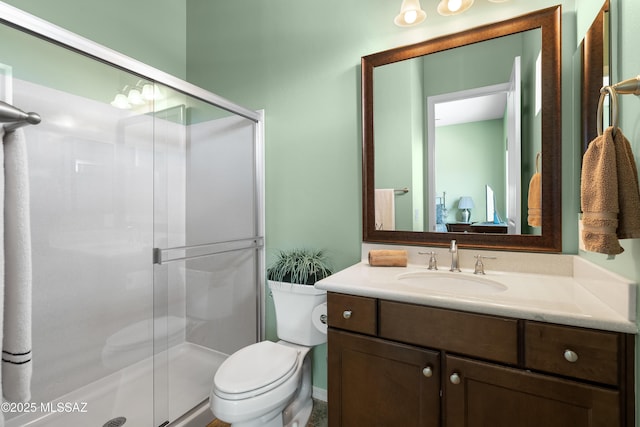 bathroom with walk in shower, vanity, and toilet