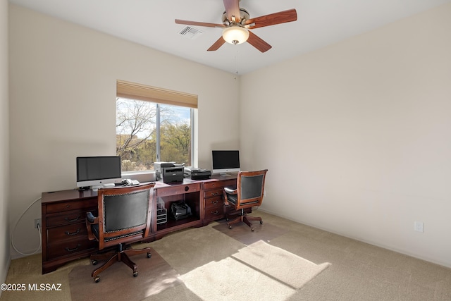 office with light carpet and ceiling fan