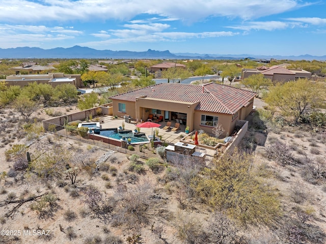 birds eye view of property with a mountain view