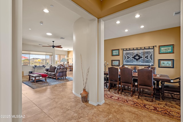 tiled dining space with ceiling fan