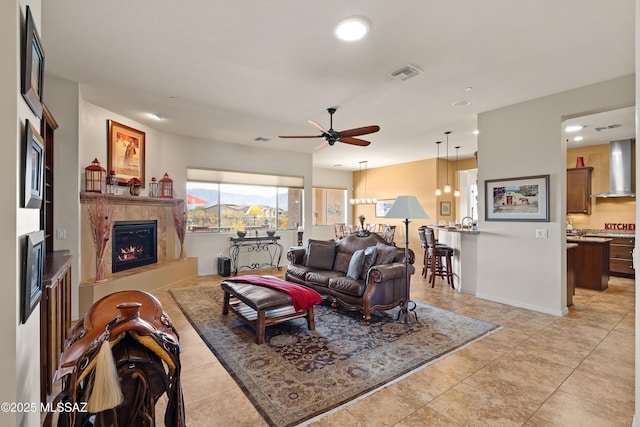 tiled living room featuring ceiling fan