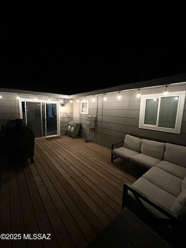 deck at night with outdoor lounge area