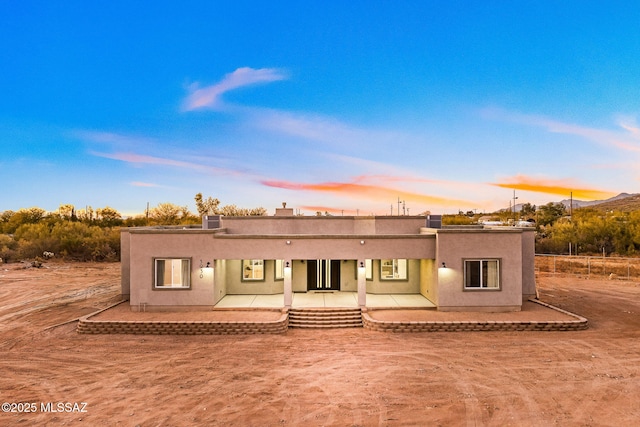 view of front of home featuring central AC unit and a patio area