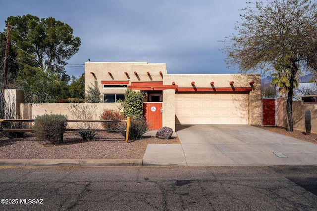 pueblo-style house featuring a garage