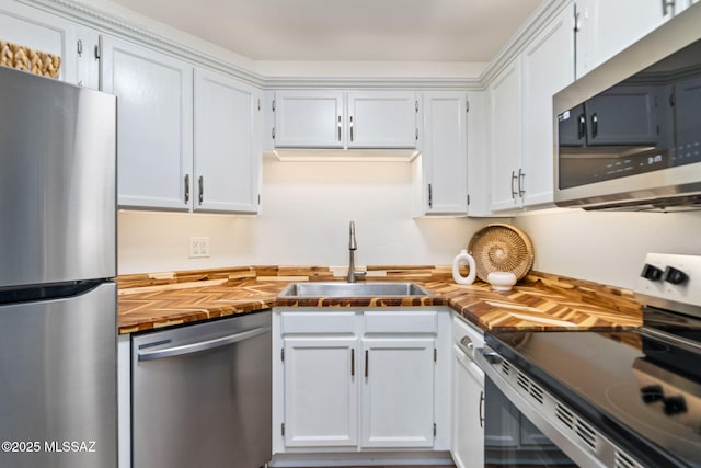 kitchen featuring white cabinetry, stainless steel appliances, and sink