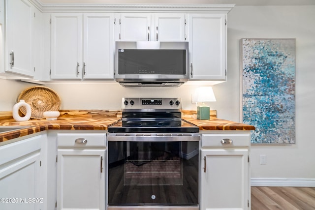 kitchen featuring white cabinetry, stainless steel appliances, and light hardwood / wood-style floors