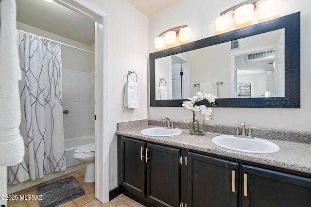 full bathroom featuring tile patterned floors, vanity, toilet, and shower / bath combo with shower curtain