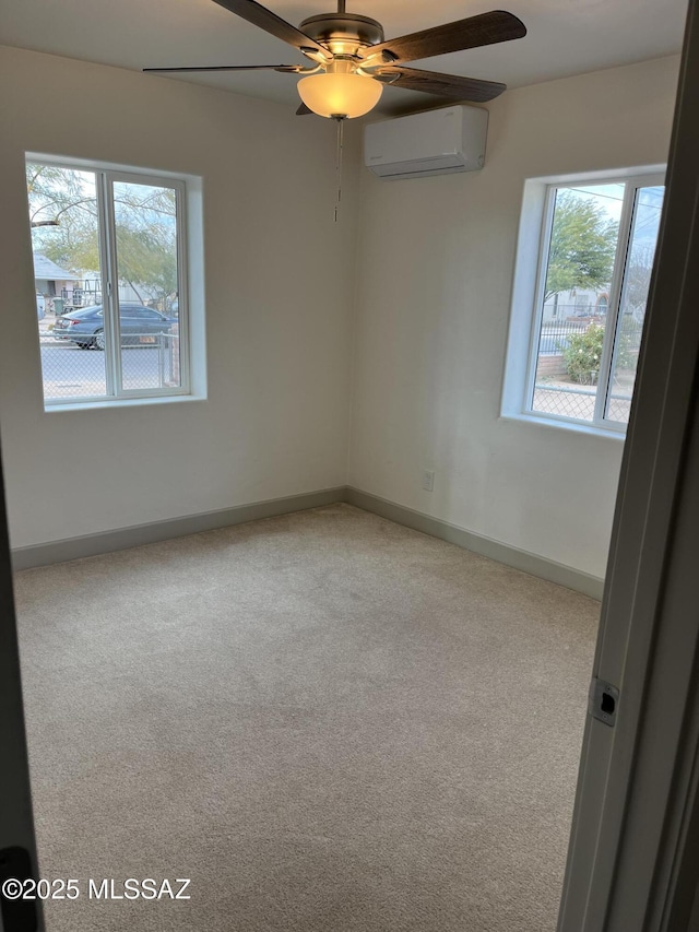 carpeted empty room with ceiling fan and a wall unit AC