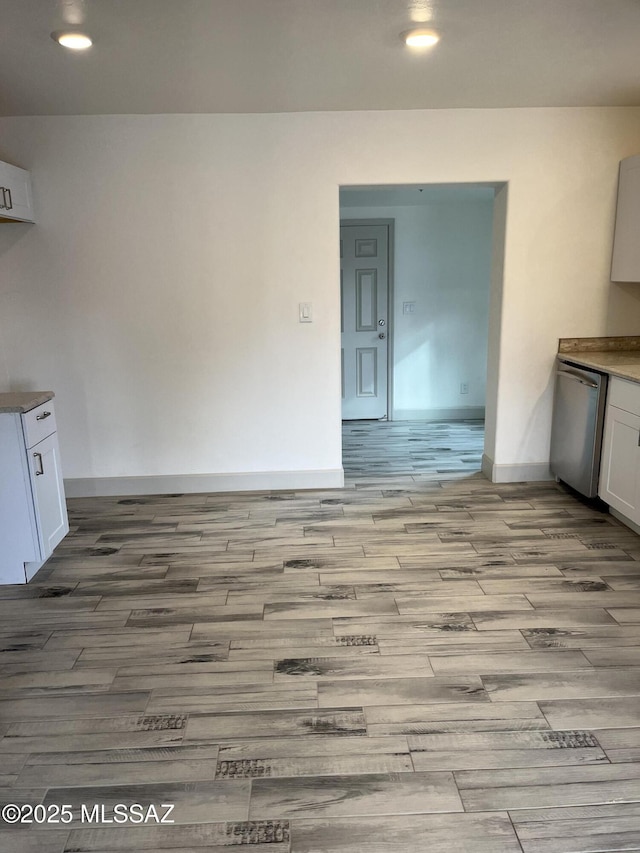 kitchen with white cabinetry, dishwasher, and light wood-type flooring