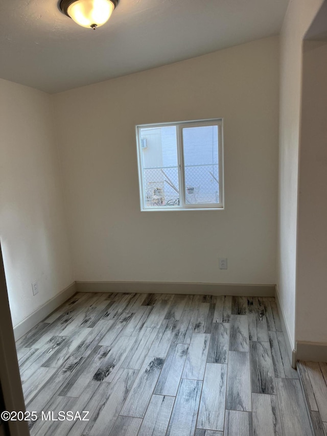 empty room with light hardwood / wood-style flooring