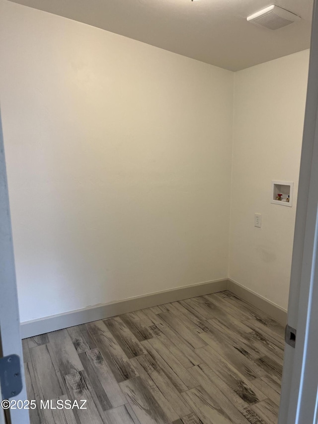 unfurnished room with hardwood / wood-style flooring