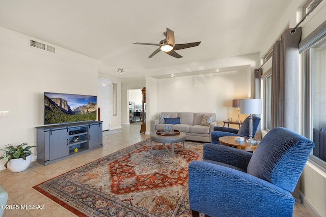 tiled living room with ceiling fan