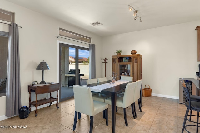 dining space featuring light tile patterned flooring