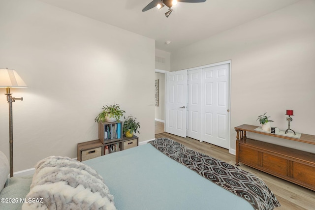 bedroom featuring hardwood / wood-style floors, a closet, and ceiling fan