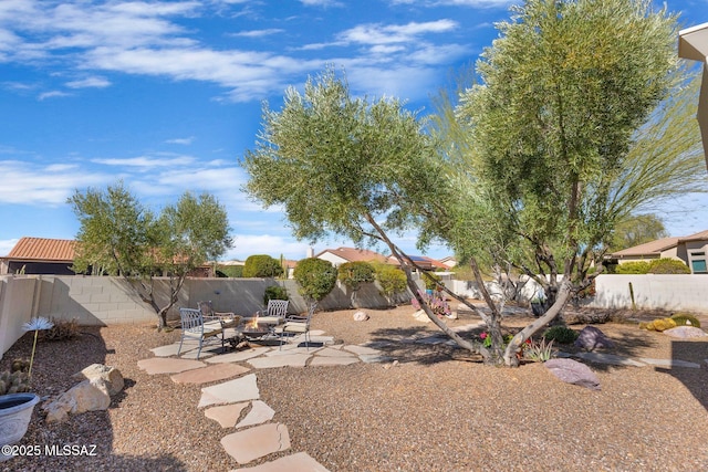 view of yard featuring an outdoor fire pit and a patio area