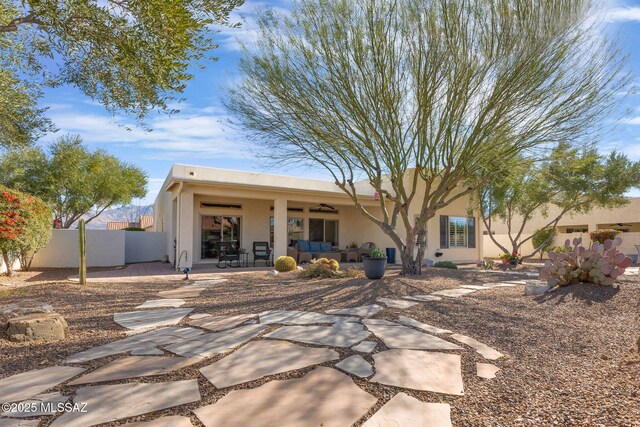 rear view of property featuring a patio area, outdoor lounge area, and ceiling fan