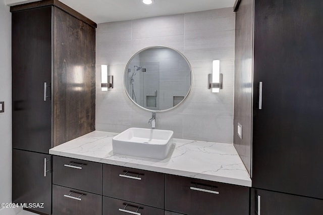 bathroom featuring vanity and tasteful backsplash