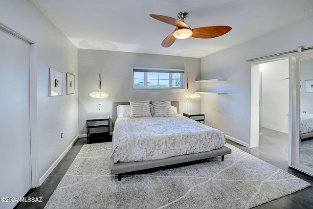 bedroom featuring a barn door and ceiling fan