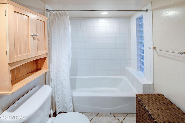 bathroom featuring toilet, tile patterned flooring, and shower / bath combo with shower curtain