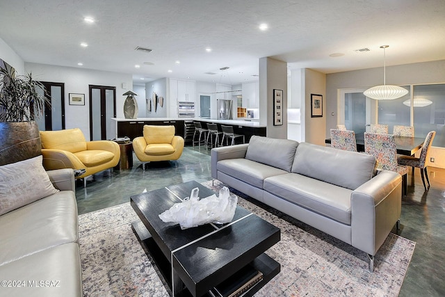 living room with concrete flooring and a textured ceiling