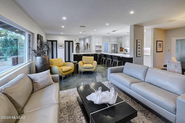 living room featuring concrete flooring