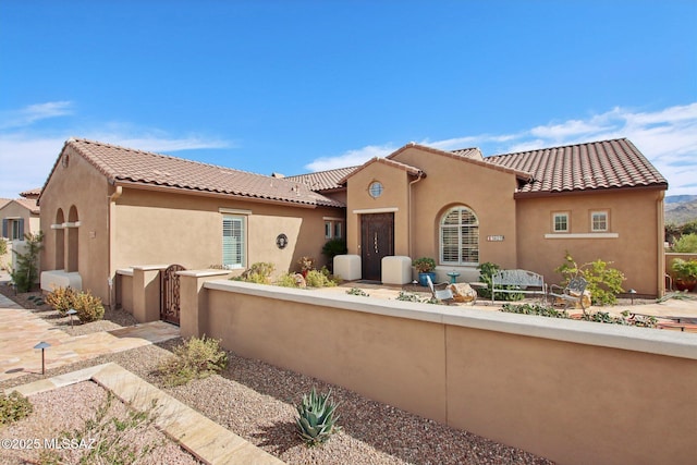 36239 S Cypress Dr, Saddlebrooke, AZ 85739 - view of front facade featuring fence, a tile roof, and stucco siding