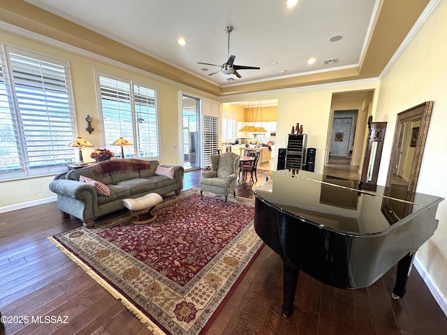 36239 S Cypress Dr, Saddlebrooke, AZ 85739 - living room featuring baseboards, visible vents, ornamental molding, and dark wood-style flooring
