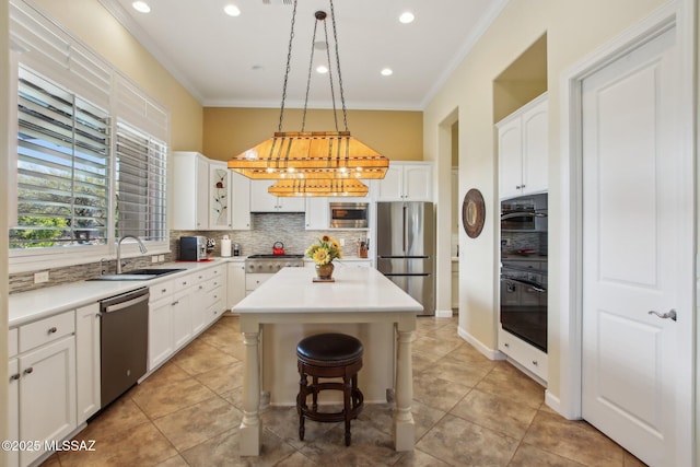 36239 S Cypress Dr, Saddlebrooke, AZ 85739 - kitchen featuring tasteful backsplash, appliances with stainless steel finishes, ornamental molding, a kitchen island, and a sink