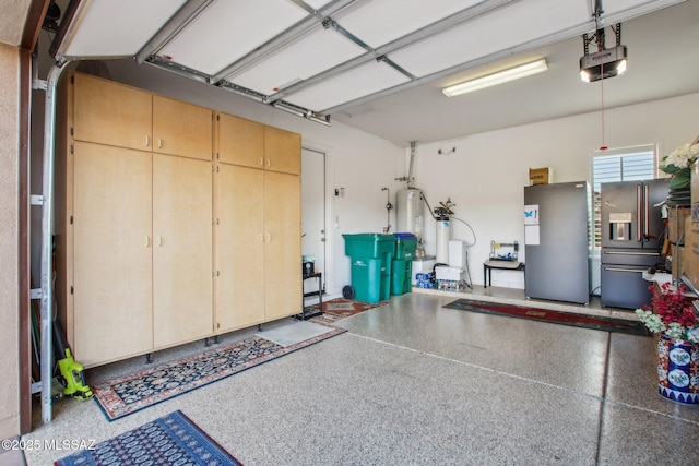 36239 S Cypress Dr, Saddlebrooke, AZ 85739 - garage with freestanding refrigerator, a garage door opener, gas water heater, and stainless steel fridge with ice dispenser