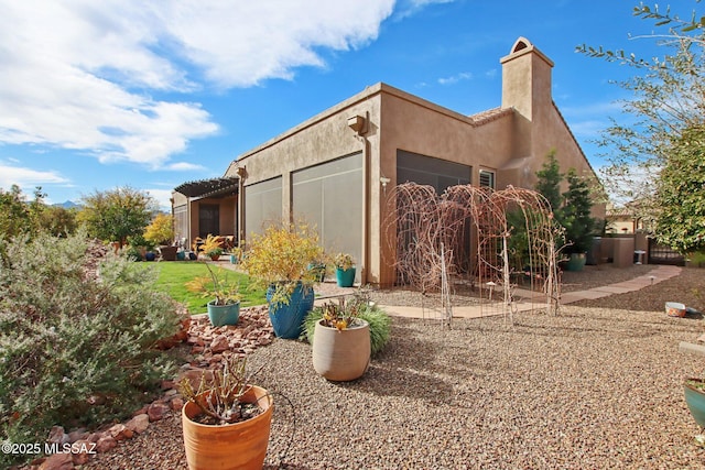 36239 S Cypress Dr, Saddlebrooke, AZ 85739 - view of property exterior with a garage, a chimney, and stucco siding