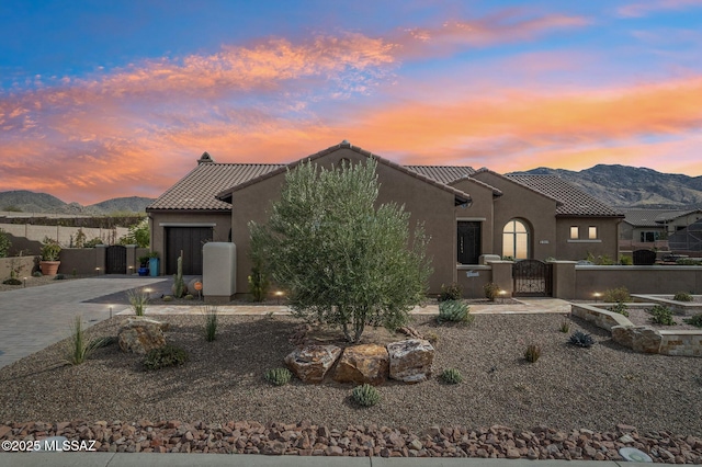 36239 S Cypress Dr, Saddlebrooke, AZ 85739 - view of front of property with a garage, fence, a mountain view, and decorative driveway