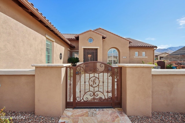 36239 S Cypress Dr, Saddlebrooke, AZ 85739 - exterior space featuring a gate, fence, a tiled roof, and stucco siding